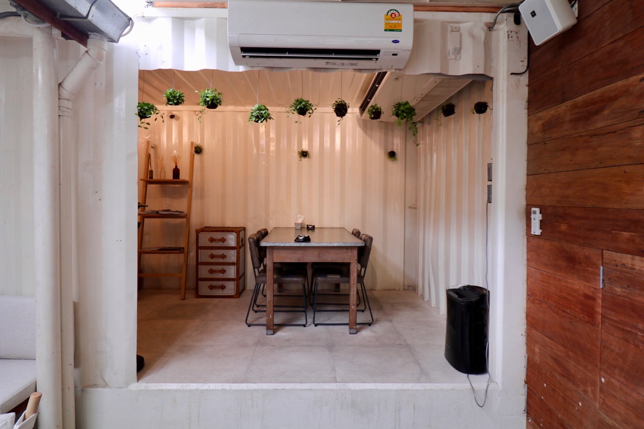 The restaurant extends into some converted containers in the backyard